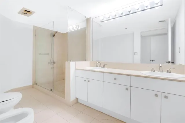 a bathroom with a toilet sink and shower