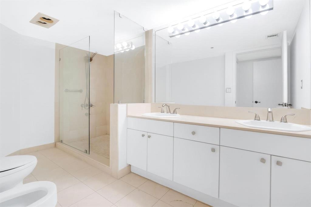 8855 Collins Avenue, Unit 2D Surfside, FL 33154 - Photo 15 of 25 a bathroom with a toilet sink and shower