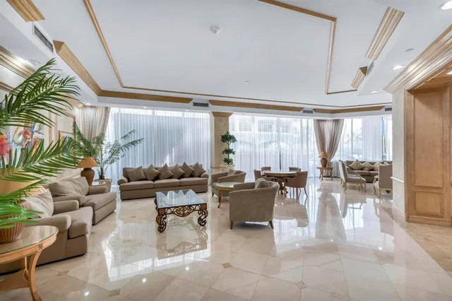 a living room with patio furniture and a large window