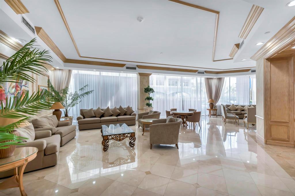 8855 Collins Avenue, Unit 2D Surfside, FL 33154 - Photo 17 of 25 a living room with patio furniture and a large window