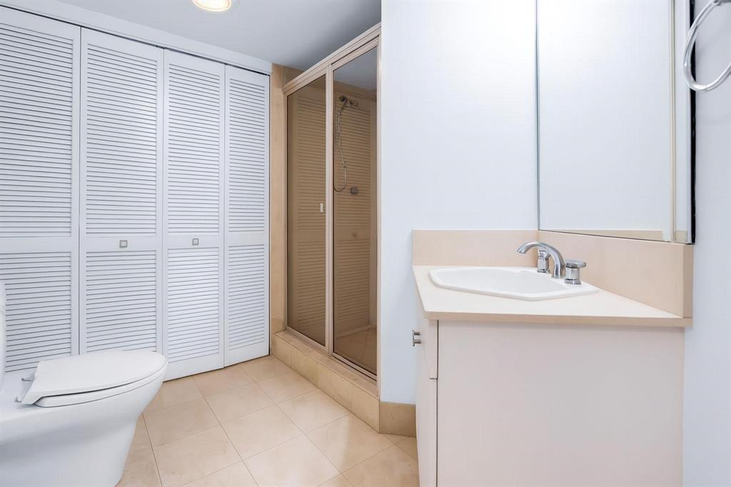8855 Collins Avenue, Unit 2D Surfside, FL 33154 - Photo 10 of 25 a bathroom with a sink a toilet and shower