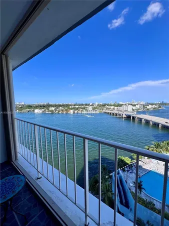 a view of a balcony with wooden floor and city view