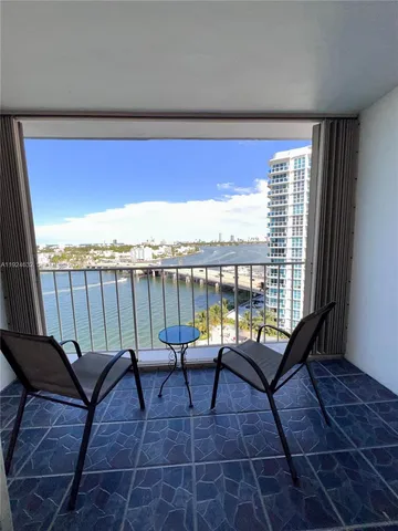 a view of a balcony with lake view and a couches