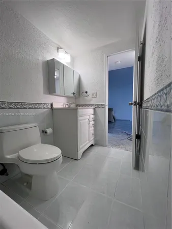 a bathroom with a toilet sink and shower