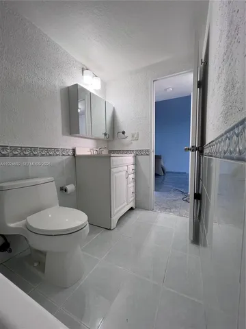 a bathroom with a toilet sink and shower