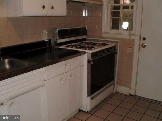 443 South Wickham Road Baltimore, MD 21229 - Photo 2 of 9 a kitchen with granite countertop a stove and a cabinets