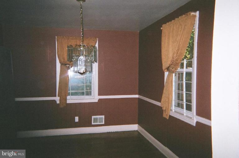 443 South Wickham Road Baltimore, MD 21229 - Photo 4 of 9 a view of a livingroom with an empty space and a window
