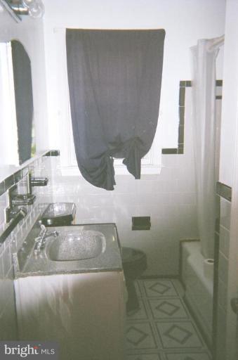 443 South Wickham Road Baltimore, MD 21229 - Photo 5 of 9 a bathroom with a sink and a mirror
