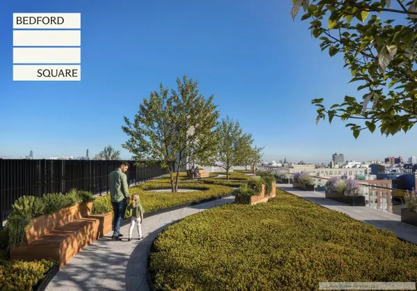 swimming pool with outdoor seating and green space