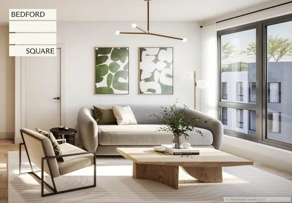 a living room with furniture large window and wooden floor