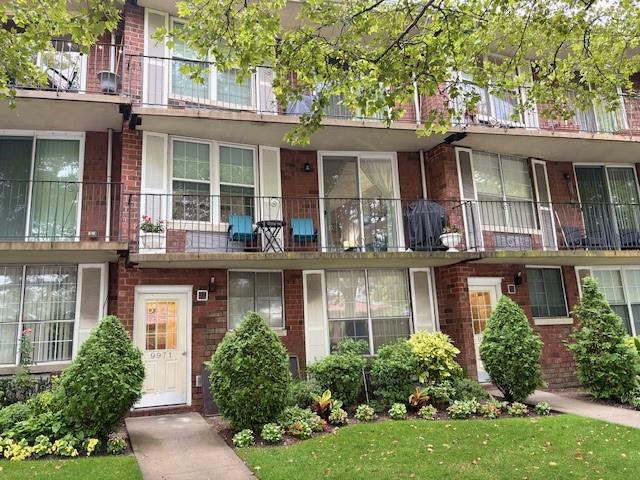 9971 Shore Road, Unit 9C Brooklyn, NY 11209 - Photo 1 of 9 front view of a house with a yard