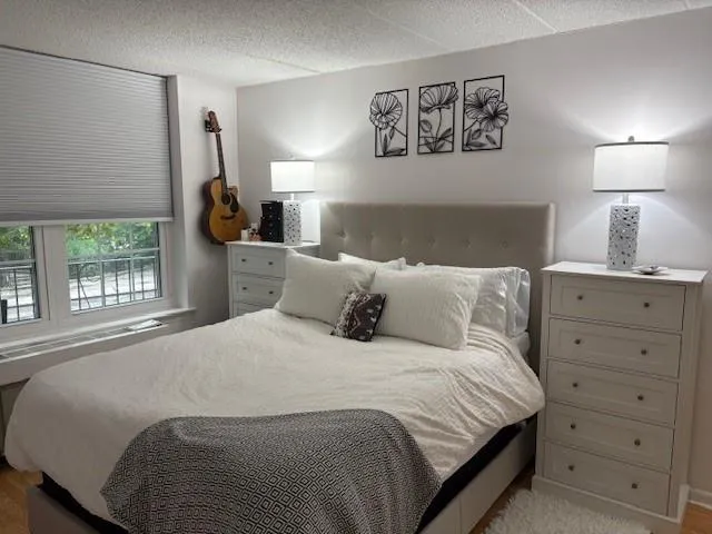 a bedroom with a bed and a window