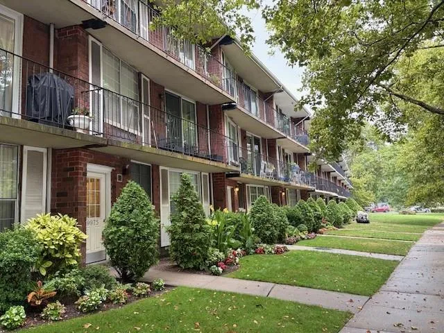 a view of a brick building next to a yard
