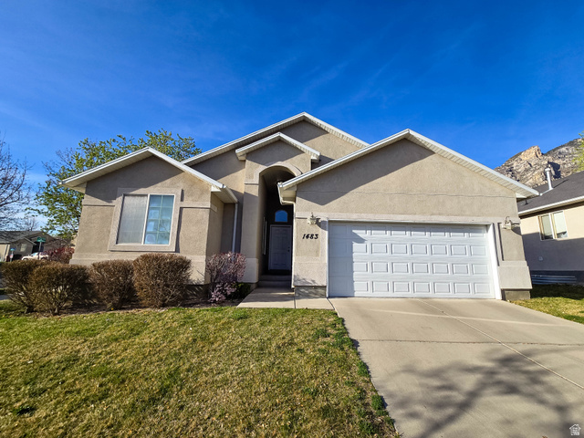 1483 East 1230th Street South Provo, UT 84606 - Photo 1 of 1 Single story home featuring a garage, concrete driveway, stucco siding, and a front yard