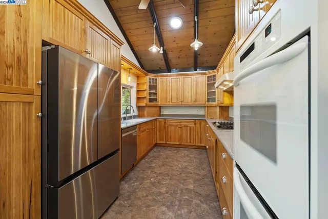 a kitchen with granite countertop a refrigerator and a sink