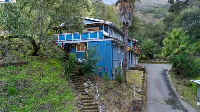 a view of a house with a yard and sitting area