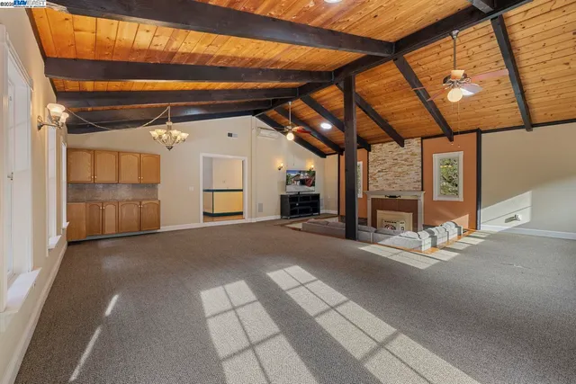 a view of empty room with wooden floor and windows