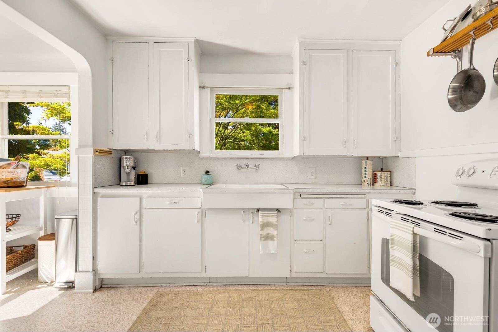 1002 South Adams Street Tacoma, WA 98405 - Photo 13 of 40 a kitchen with white cabinets and appliances