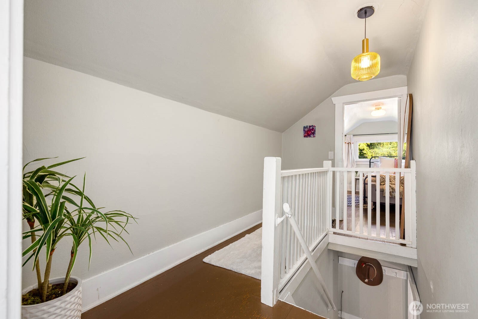 1002 South Adams Street Tacoma, WA 98405 - Photo 24 of 40 a view of a hallway to a dining room with chandelier