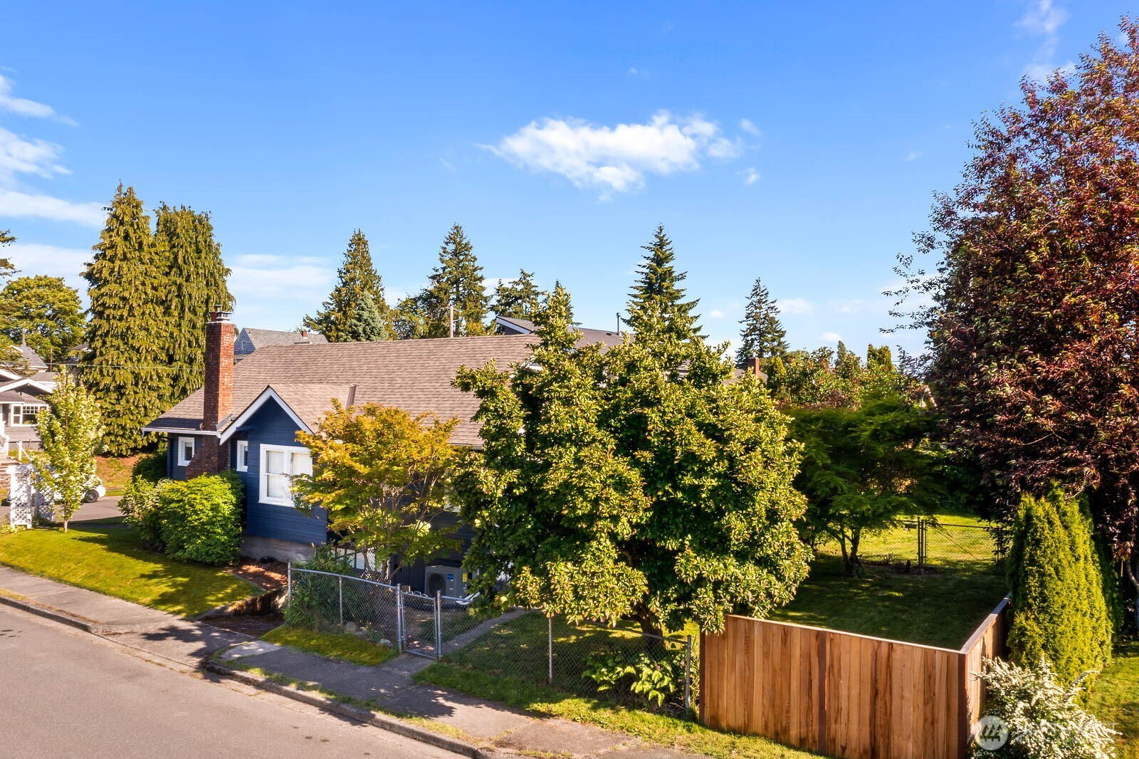 1002 South Adams Street Tacoma, WA 98405 - Photo 37 of 40 a view of a house with a tree in the background