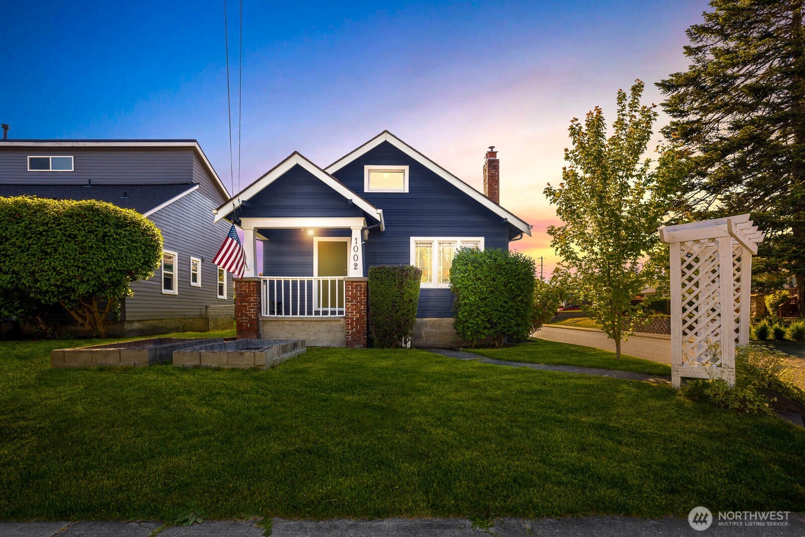 1002 South Adams Street Tacoma, WA 98405 - Photo 39 of 40 a front view of a house with a yard