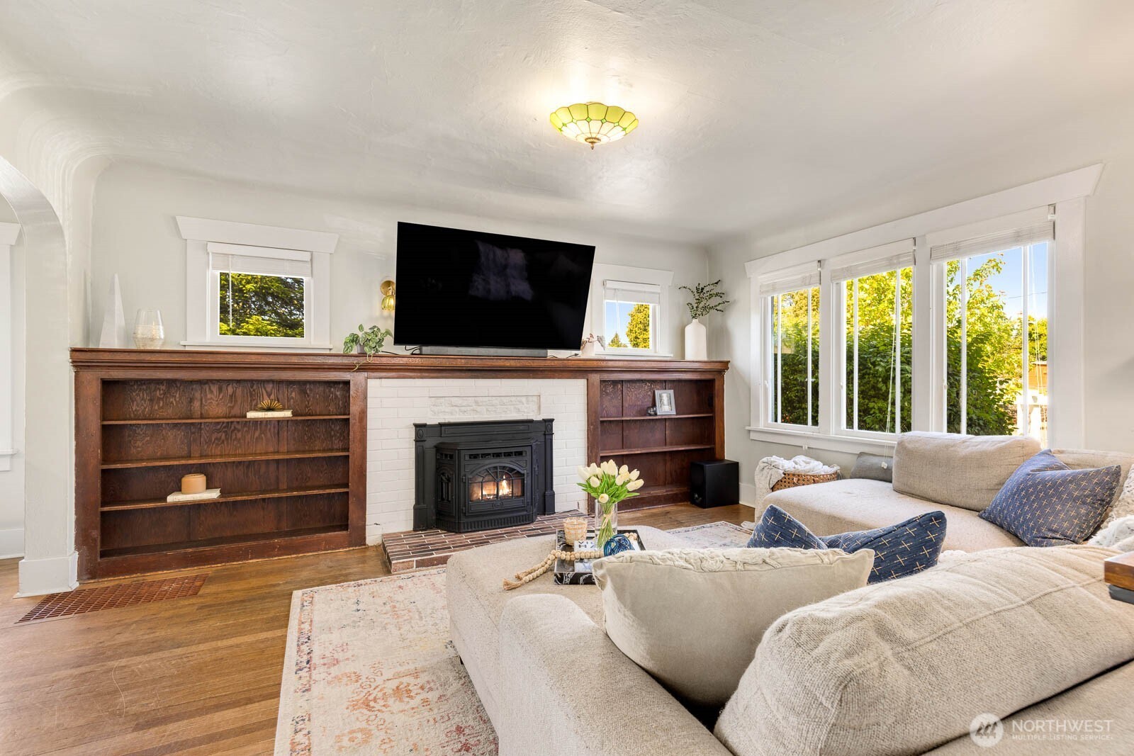 1002 South Adams Street Tacoma, WA 98405 - Photo 6 of 40 a living room with furniture a flat screen tv and a fireplace
