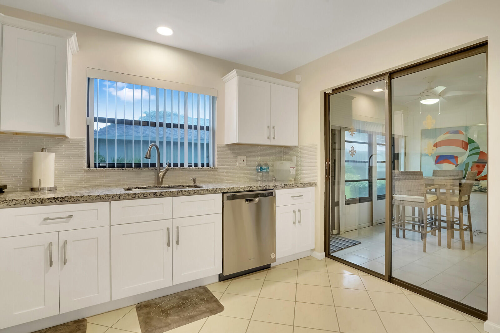 4180 Mango Tree Court, Unit B Boynton Beach, FL 33436 - Photo 12 of 25 a kitchen with granite countertop a sink a stove cabinets and stainless steel appliances