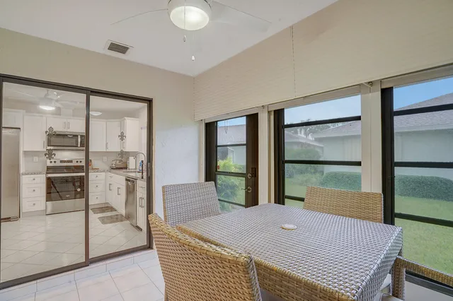 a room with pool table and windows