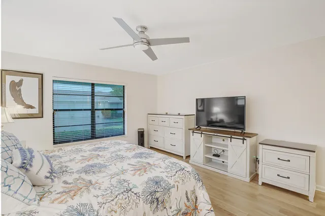 a bedroom with a bed and a flat tv screen in it