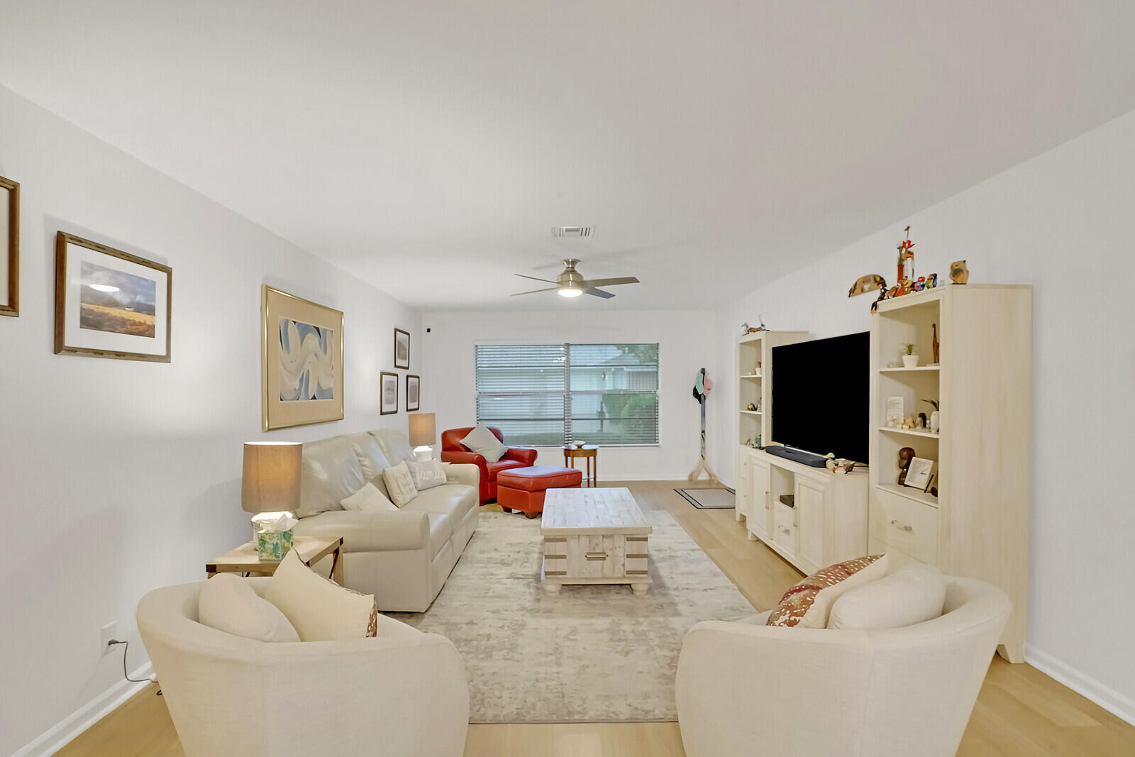 4180 Mango Tree Court, Unit B Boynton Beach, FL 33436 - Photo 8 of 25 a living room with furniture and a flat screen tv