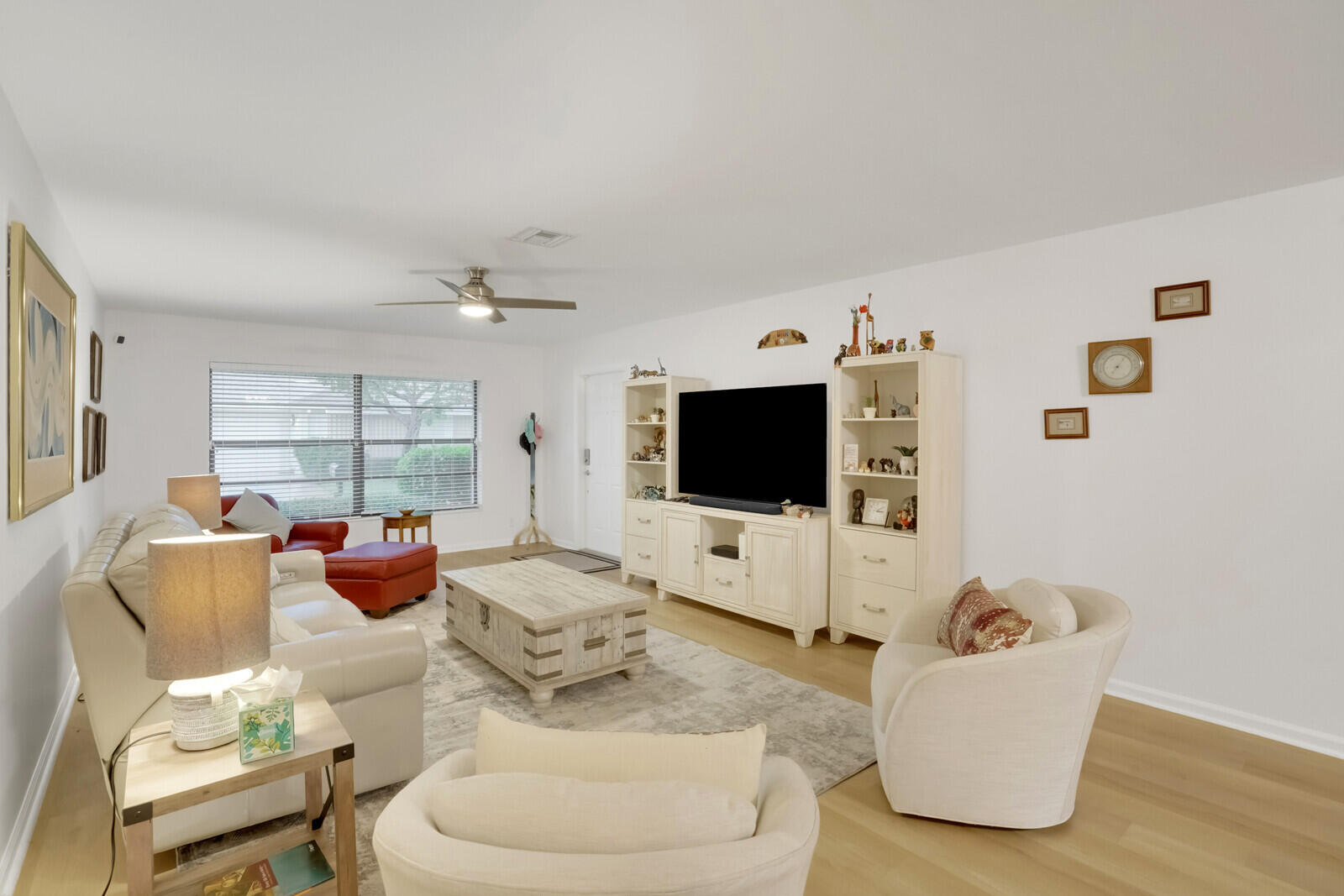 4180 Mango Tree Court, Unit B Boynton Beach, FL 33436 - Photo 9 of 25 a living room with furniture and a flat screen tv
