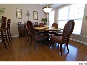 208 Sand Paver Way Fort Mill, SC 29708 - Photo 4 of 16 a view of a dining room with furniture and wooden floor