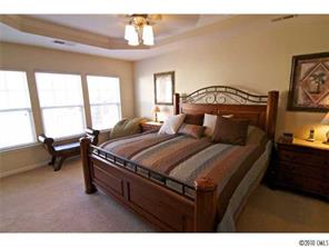 208 Sand Paver Way Fort Mill, SC 29708 - Photo 9 of 16 a bedroom with a bed a table and chair