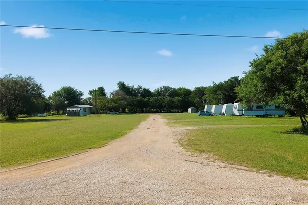 a view of a park with large trees