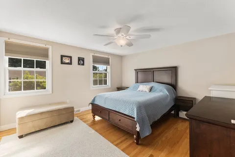 a spacious bedroom with a bed and a window