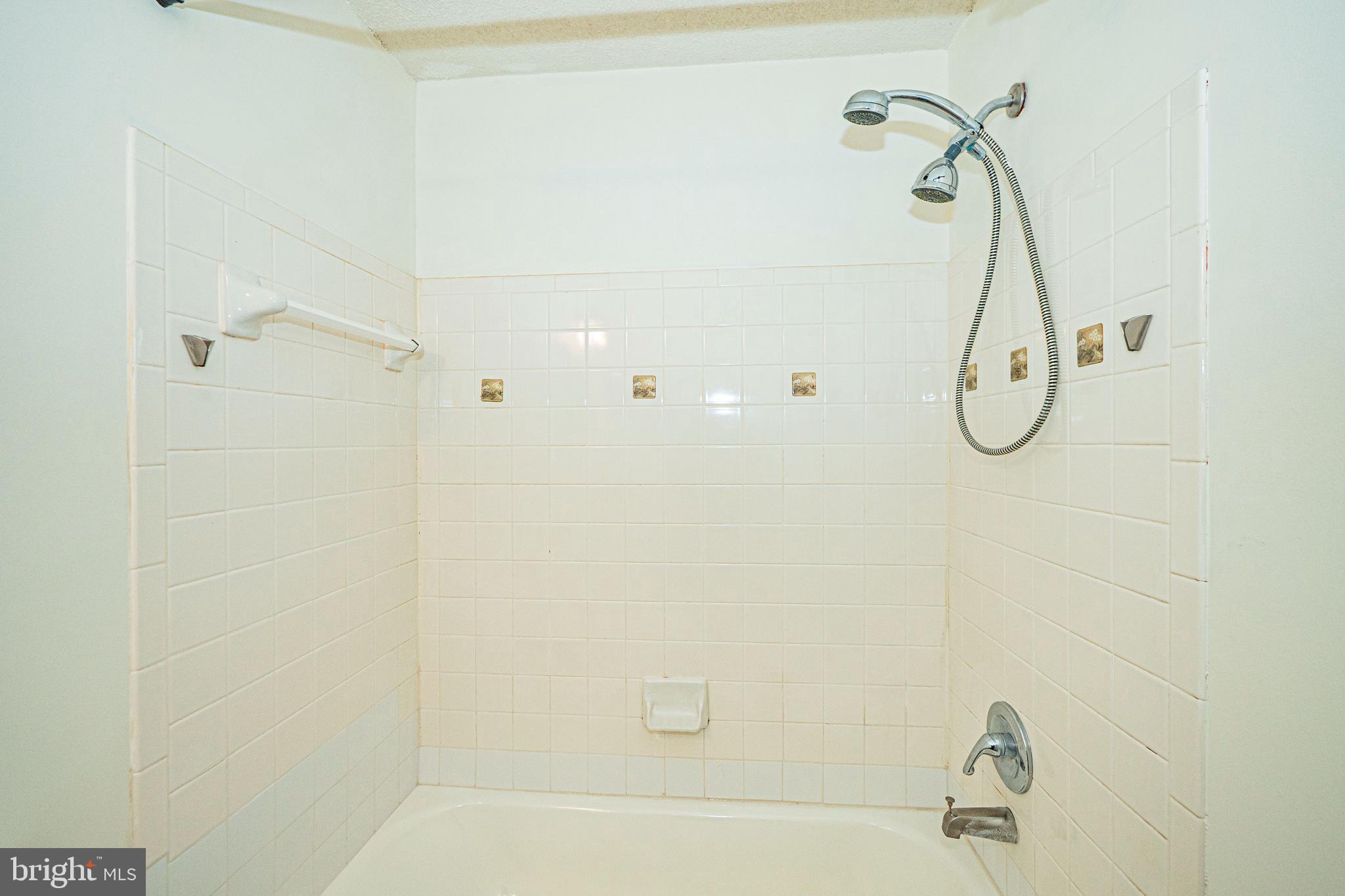 2600 Camelback Lane, Unit 6 Silver Spring, MD 20906 - Photo 25 of 40 a bathroom with a bath tub with a shower