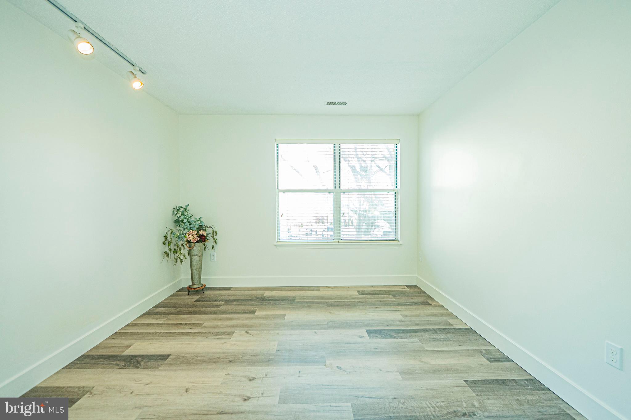 2600 Camelback Lane, Unit 6 Silver Spring, MD 20906 - Photo 33 of 40 an empty room with wooden floor and windows