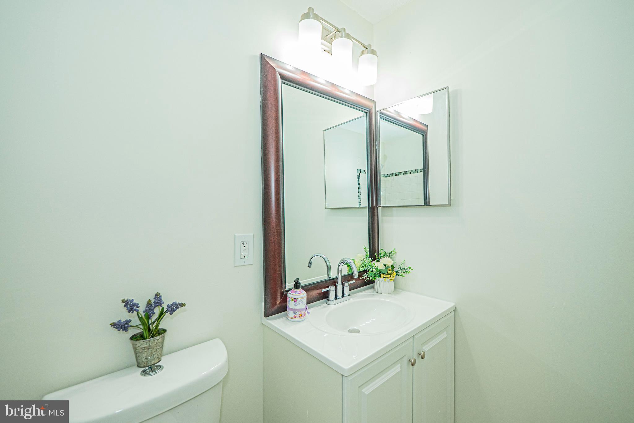 2600 Camelback Lane, Unit 6 Silver Spring, MD 20906 - Photo 36 of 40 a bathroom with a sink vanity and a mirror