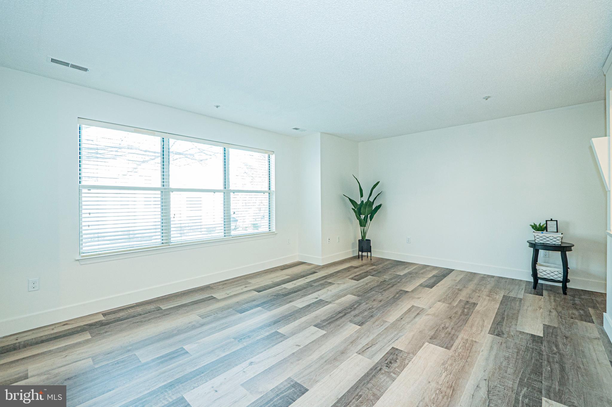 2600 Camelback Lane, Unit 6 Silver Spring, MD 20906 - Photo 6 of 40 a bedroom with a bed and a potted plant