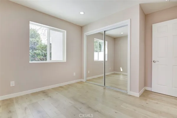 a bathroom with a granite countertop sink toilet a mirror and shower