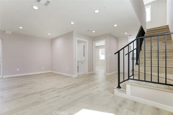 a view of a kitchen with dishwasher and white cabinets