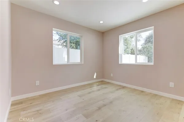 an empty room with windows and closet