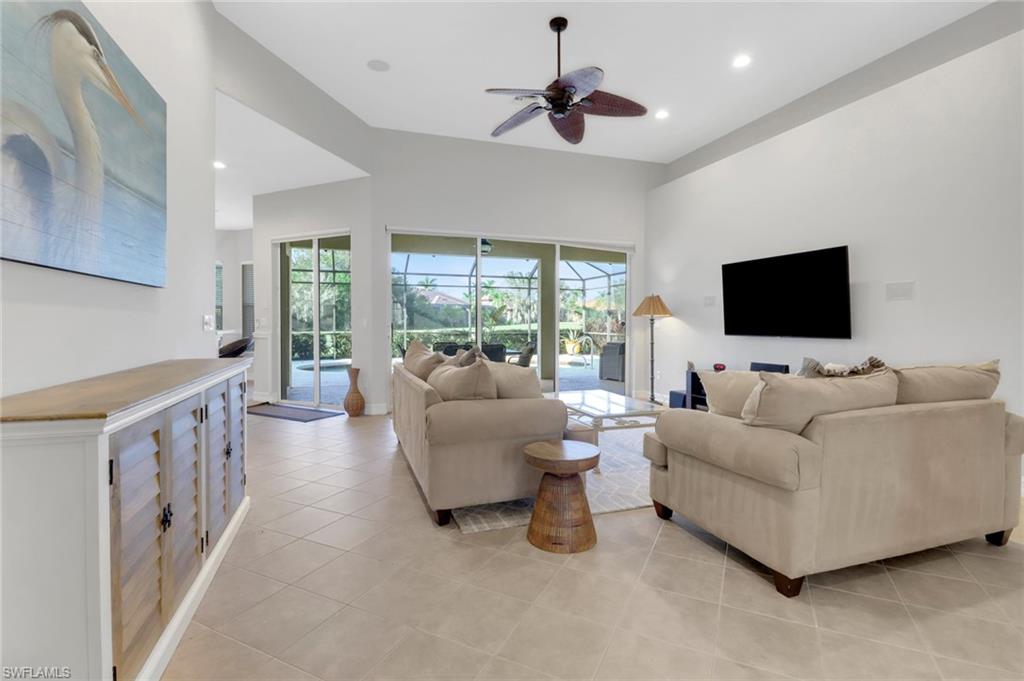 6757 Bent Grass Drive Naples, FL 34113 - Photo 5 of 27 a living room with furniture and a flat screen tv