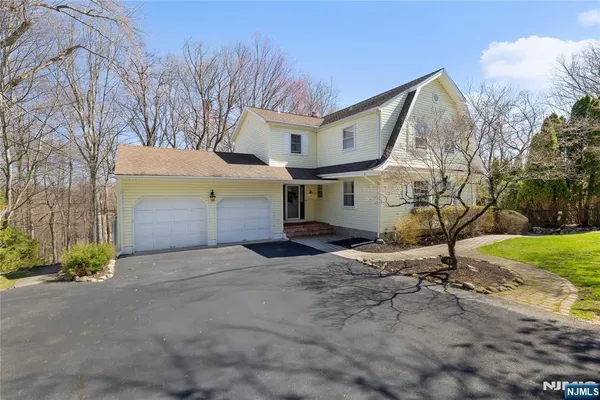 a view of a house with a yard and garage