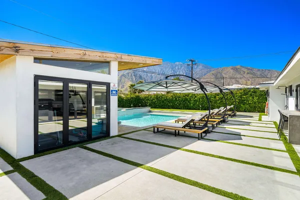 a view of a patio with a table and chairs