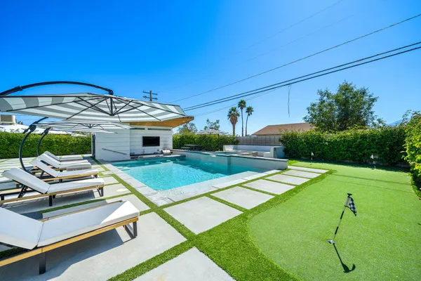 a view of a backyard with a patio and a yard