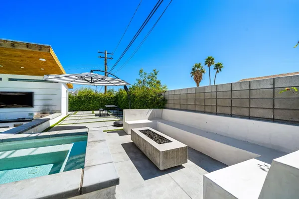 a view of a patio with couches and potted plants