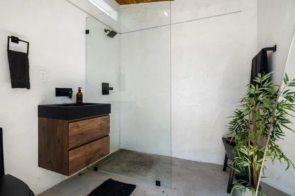 a kitchen with a refrigerator and a plant