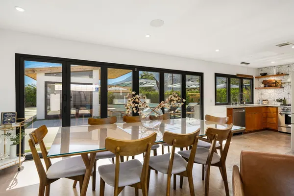 a view of a dining room with furniture and a large window