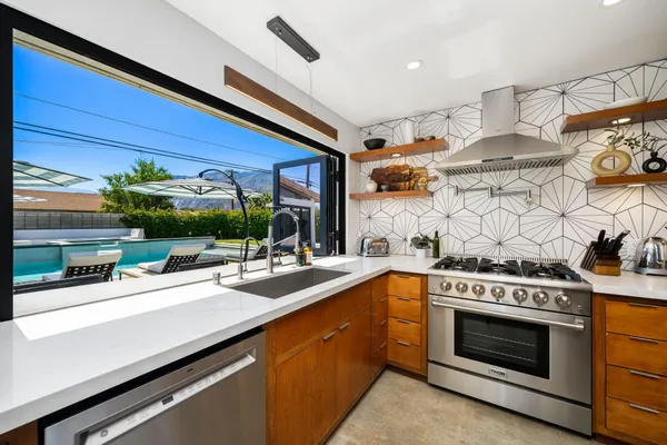 a kitchen with stainless steel appliances a stove and a cabinets